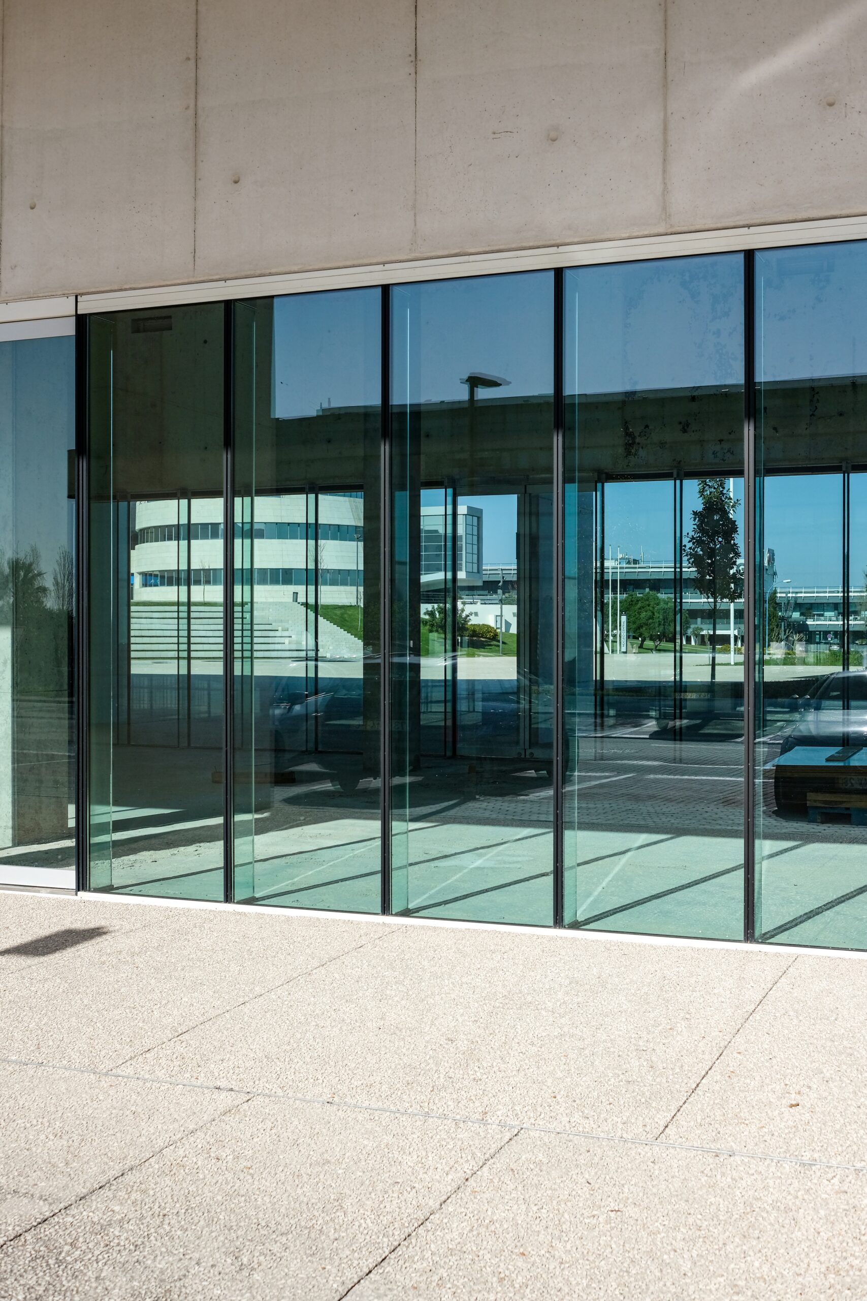 A vertical shot of the transparent doors of a commercial building